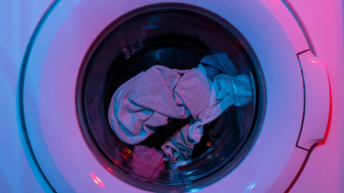Hublot d’une machine à laver rempli de linge